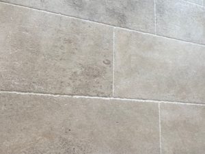 Close-up of natural limestone floor tiles in the Amphilly French collection