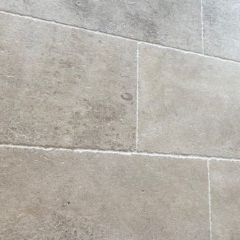 Close-up of natural limestone floor tiles in the Amphilly French collection