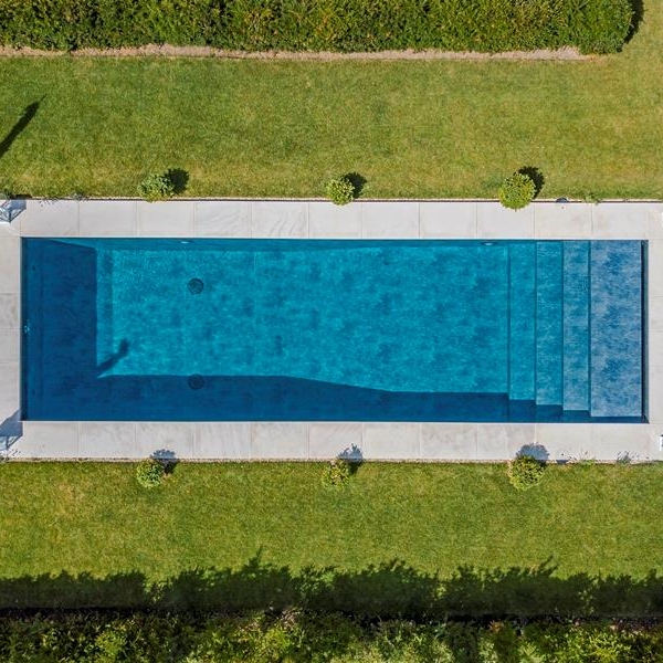 overhead shot of white mint sandpasted pool copings ws