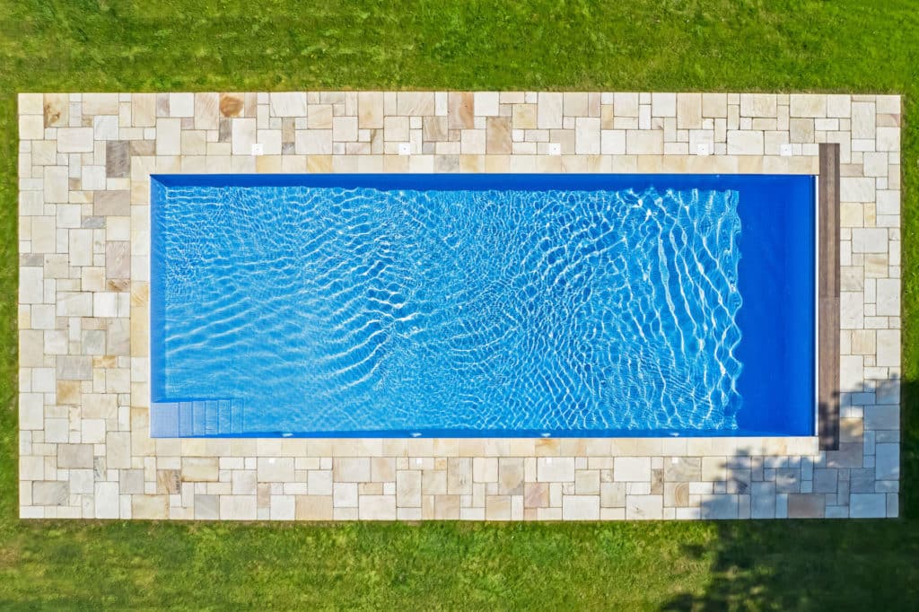 Fossil Mint natural stone swimming pool copings and matching paving from Stoneworld